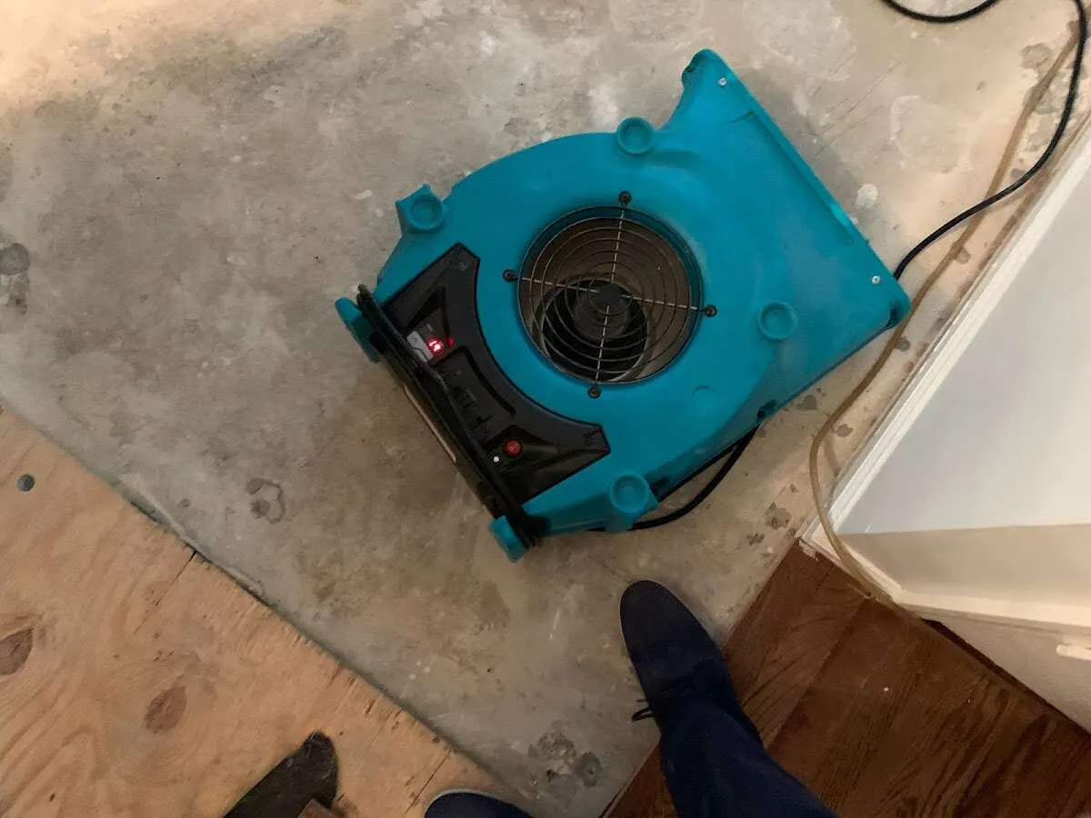 Air mover drying subfloor during Commercial Water Damage Restoration in Fuller Heights